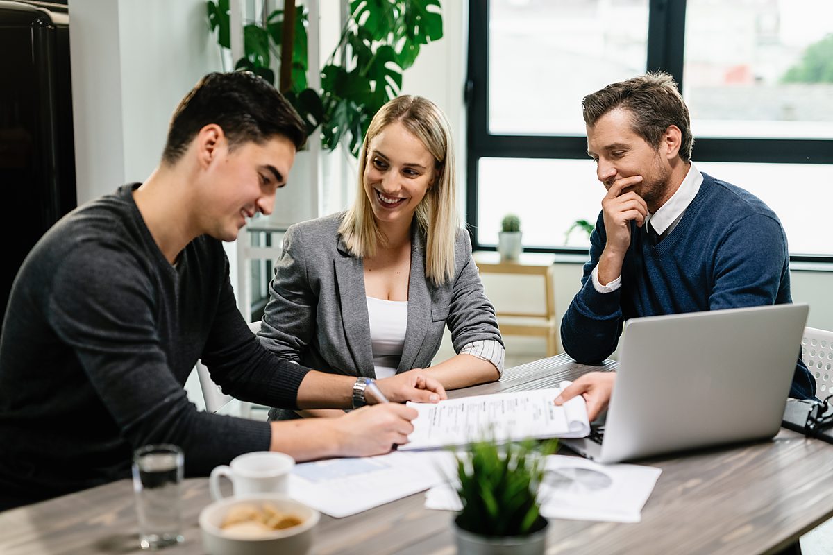 A couple reviewing loan paperwork with an adviser